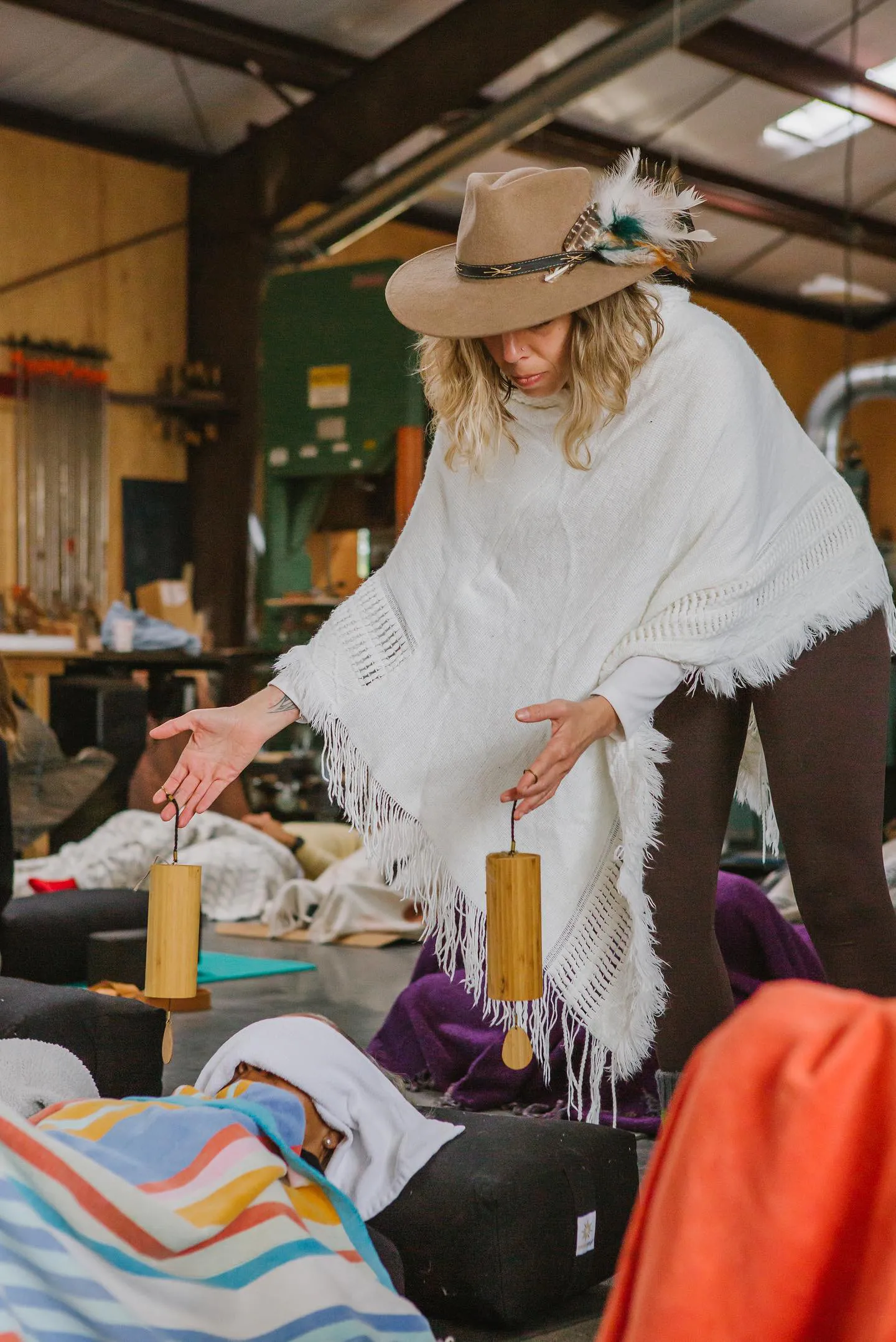 LeeAnna walking among participants with chimes during a sound healing session