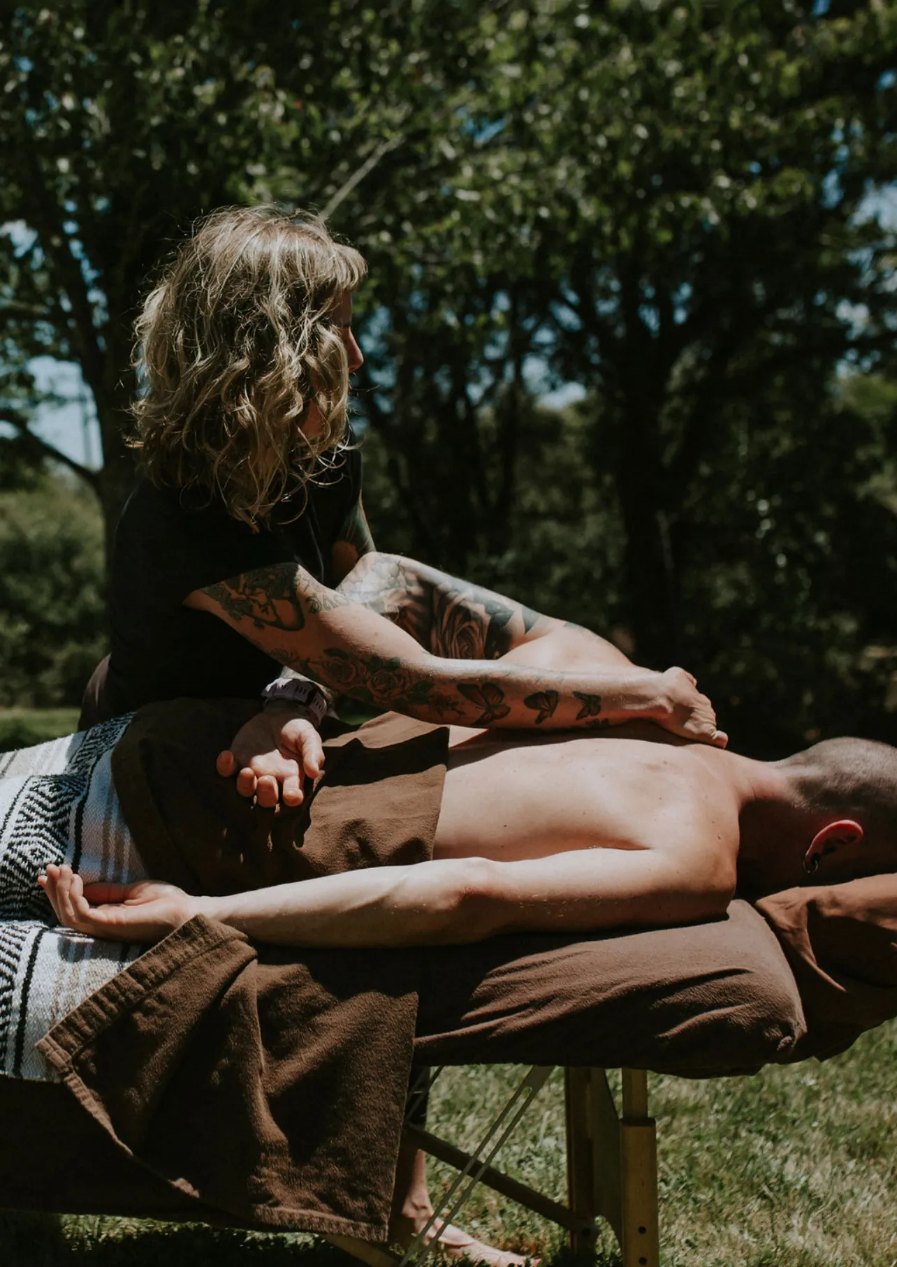 LeeAnna performing shoulder massage outdoors in natural light