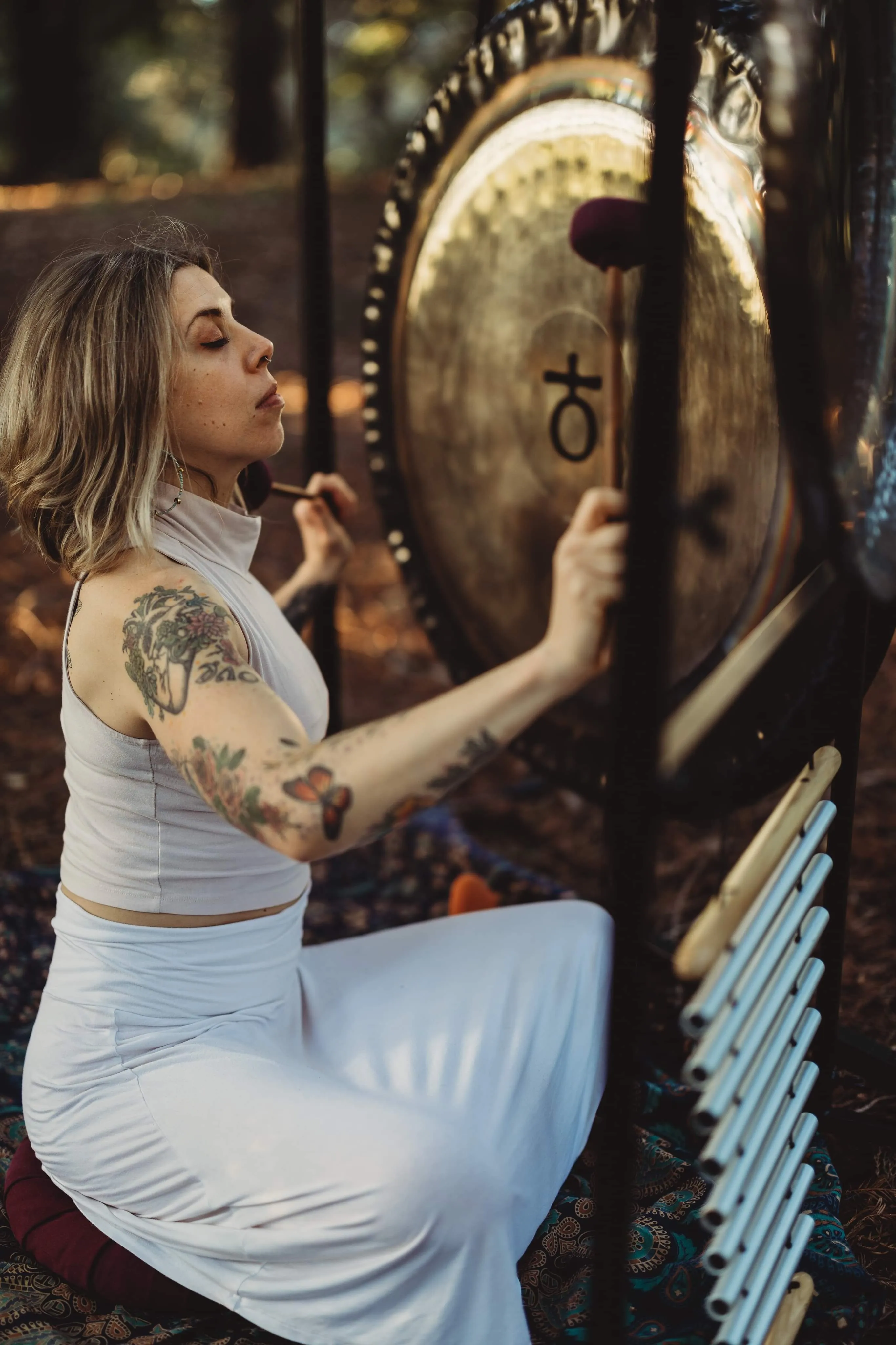LeeAnna playing a gong outside
