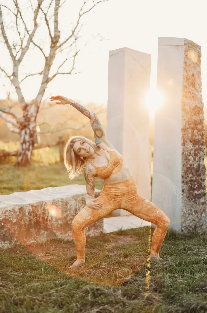 LeeAnna in a side bend yoga pose outdoors at golden hour